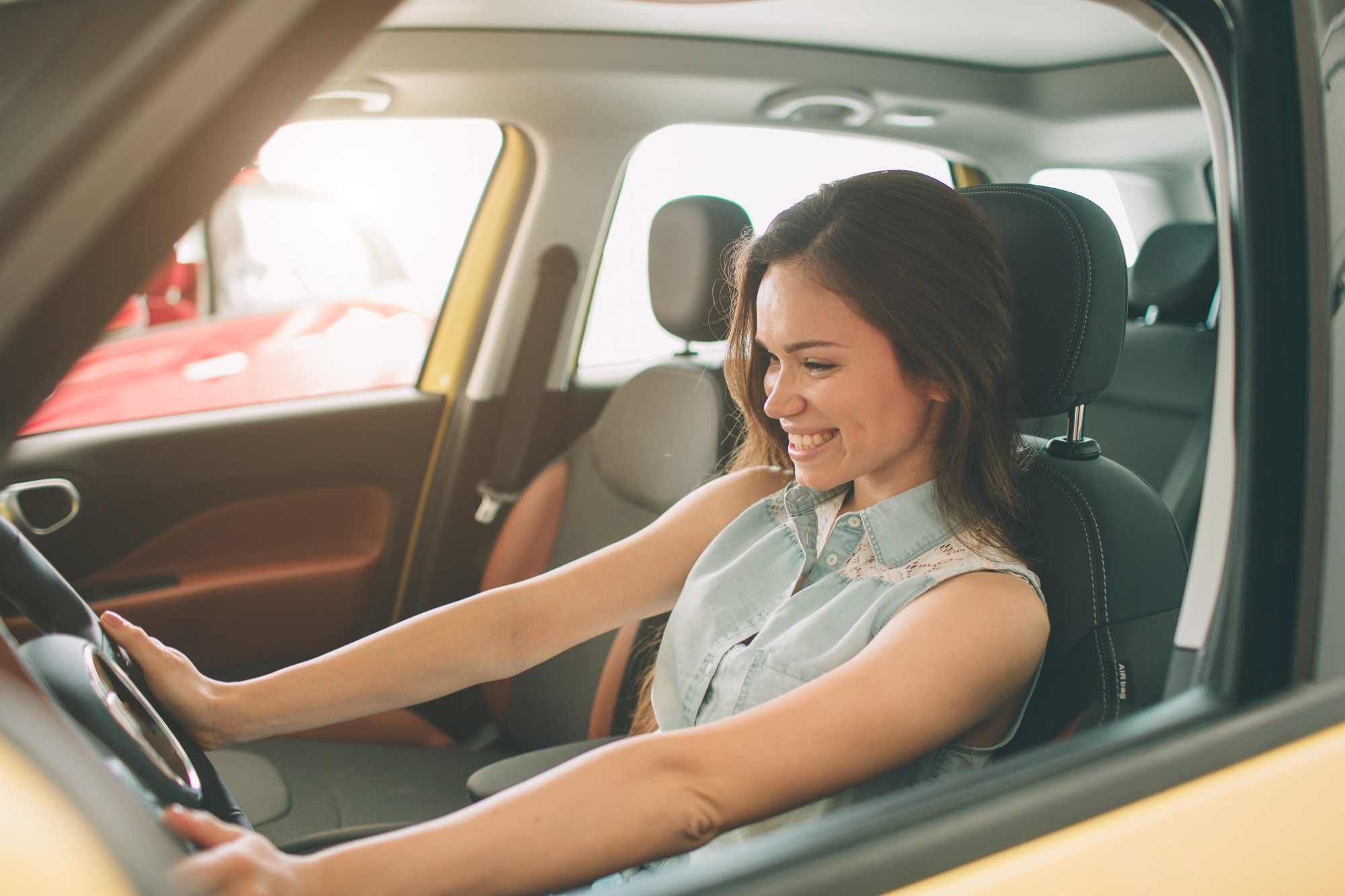 woman in car smiling